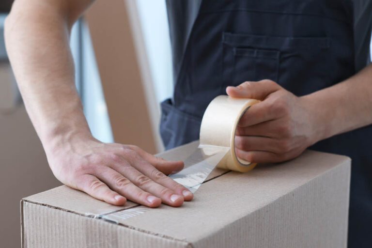 Man,Sealing,Cardboard,Box,With,Adhesive,Tape,Indoors,,Closeup